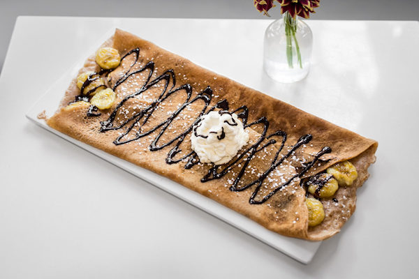 This vegan crepe at Delice & Sarrasin is served with roasted bananas, melted dark chocolate and coconut whipped cream. Photo: Delice & Sarrasin